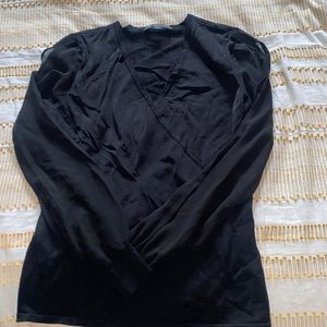 Woman’s black top. Sheer sleeves with slits